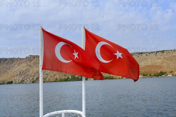 Two Turkish flags in the wind at the bow of a boat, Halfeti, Turkey, Asia