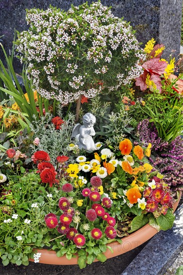 Grave with floral decoration at the cemetery church of St Stephan, Irsee, Swabia, Bavaria, Germany,