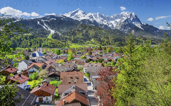 View of the village in spring with the Partenkirchen parish church in front of the Zugspitze group