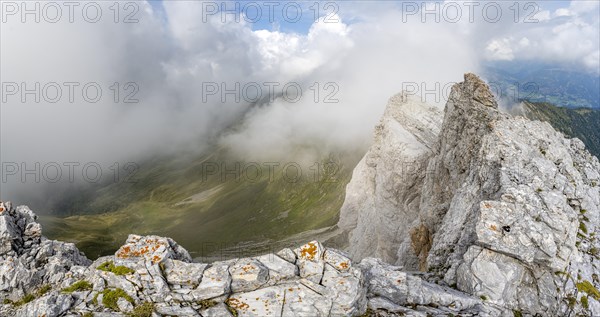 Rocky narrow summit ridge, cloudy mountain peak, summit of the Great Kinigat, Carnic Main Ridge,