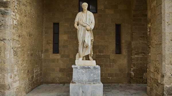 Statue of a historical figure in antique garb on a pedestal, statue from the 1st century BC,