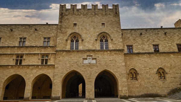 Super wide angle shot, view of the Tor tor and the facade of an old castle under a cloudy sky, sky