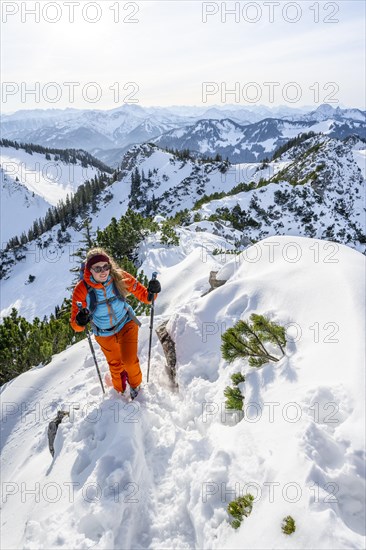Hiker in winter climbing the Aiplspitz, Mangfall mountains, Bavarian Prealps, Bavaria, Tyrol,