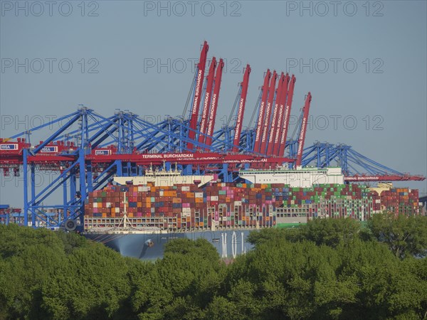 Large container harbour with astonishing amounts of stacked containers and cranes in the