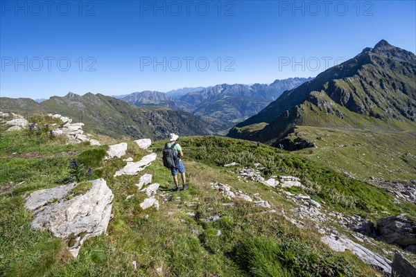 Mountaineer on hiking trail in idyllic mountain landscape, summit Steinkarspitz or Monte Antola,