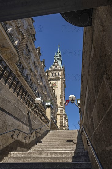View of Hamburg City Hall through a staircase passage under a blue sky, Hamburg, Germany, Europe