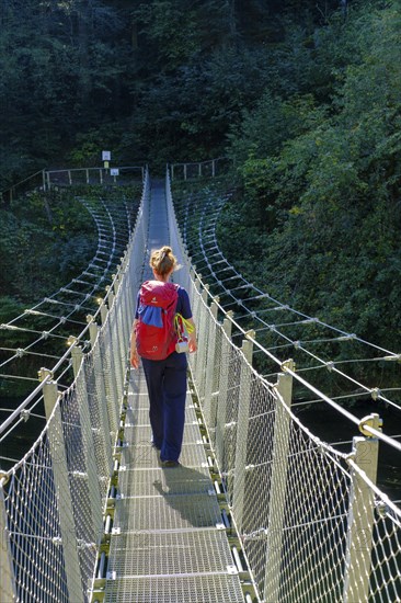 Hikers at the suspension bridge over the Danube, Inzigkofen Princely Park near Sigmaringen, Upper