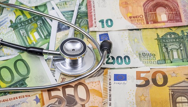 Symbolic photo cost of medicine, a stethoscope and medical instruments on a surface generated from