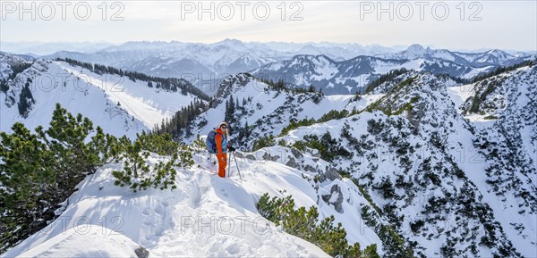 Hiker in winter climbing the Aiplspitz, Mangfall mountains, Bavarian Prealps, Bavaria, Tyrol,