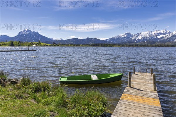 Jetty with boat on Lake Hopfensee, fishing boat, Allgaeu Alps, Hopfen am See, snow, Ostallgaeu,