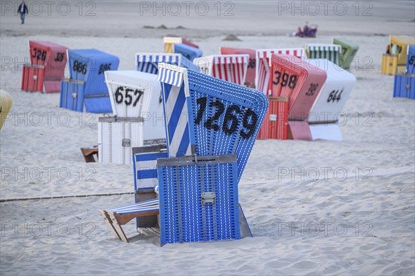 Blue beach with colourful beach chairs, relaxed atmosphere in typical beach holiday ambience, many