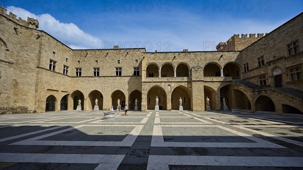Wide angle shot of a sunny courtyard with arches and columns in a castle, courtyard, Grand Master's