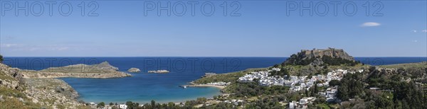 View of the Acropolis, Pallas Beach and the white houses of Lindos, Rhodes, Dodecanese archipelago,