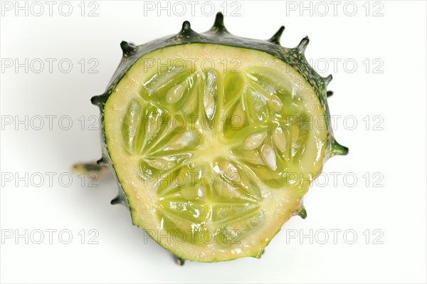 African horned melon (Cucumis metuliferus), sliced fruit on a white background
