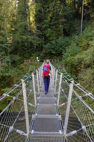 Hikers at the suspension bridge over the Danube, Inzigkofen Princely Park near Sigmaringen, Upper