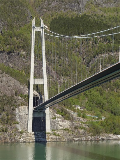 Close-up of a large bridge crossing a wide river and through rocky mountain landscapes, bridge in a