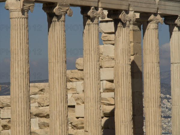 Close-up of ancient marble columns with a clear sky in the background, historical columns and ruins