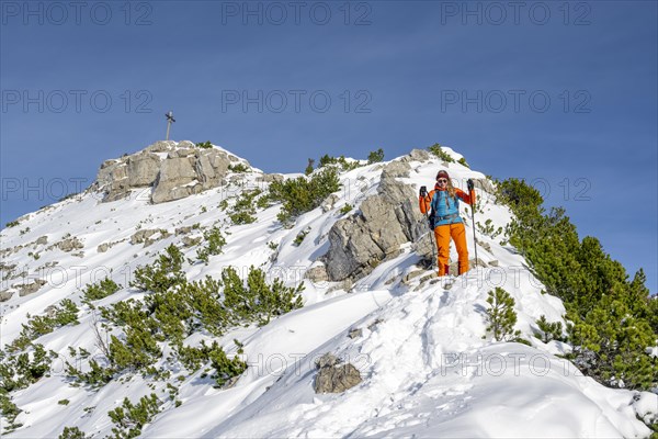 Hiker in winter climbing the Aiplspitz, Mangfall mountains, Bavarian Prealps, Bavaria, Tyrol,