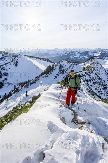 Mountaineer on the ridge of the Aiplspitz in the snow, snow-covered mountain landscape with