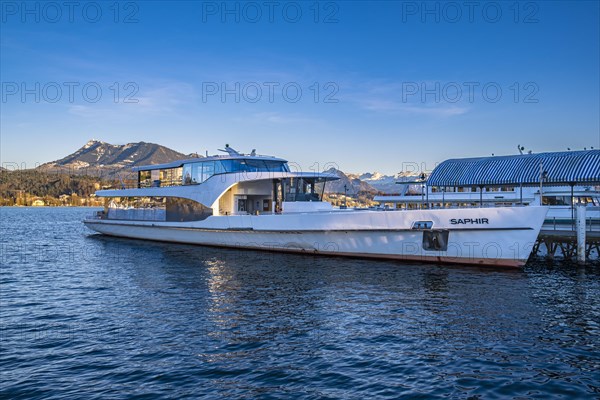 Modern boat on Lake Lucerne with mountains in the background under a blue sky, Lucerne,