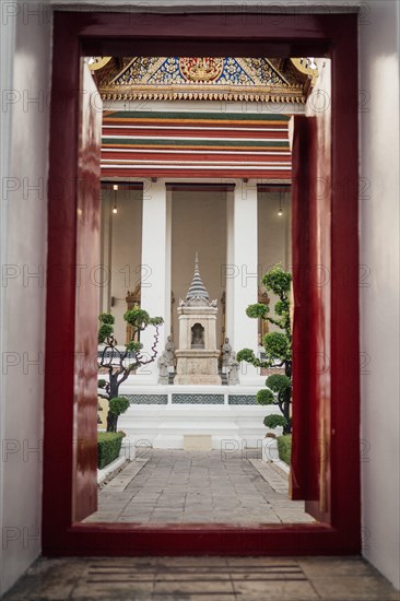 Entrance door to the temple with a view of the shrine, colourfully decorated details. Taken at