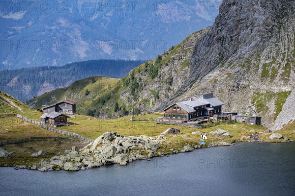 Obstanserseehuette, Obstansersee mountain lake between green mountain meadows, Carnic main ridge,