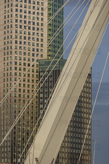 Cityscape with modern skyscrapers and a bridge element in the foreground. Bright blue sky, skyline