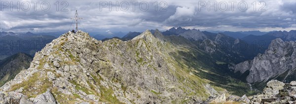 Rocky, pointed summit of the Raudenspitze or Monte Fleons with summit cross, view of the Val Fleons