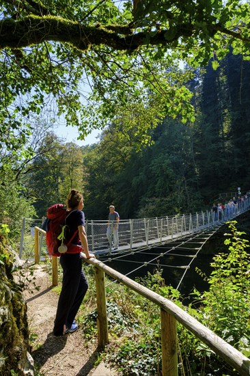 Hikers at the suspension bridge over the Danube, Inzigkofen Princely Park near Sigmaringen, Upper