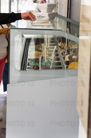 Customers buying ice cream in an ice cream parlor on the street
