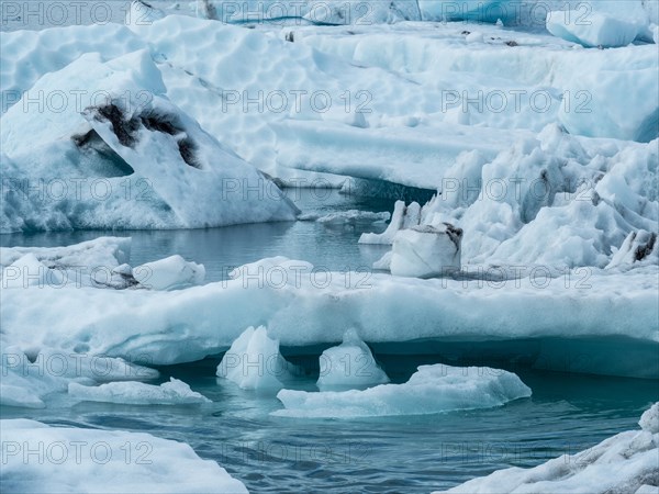 Glacier landscape with snow-covered icebergs and an ice-cold watercourse, Ice Lake, Iceland, Europe