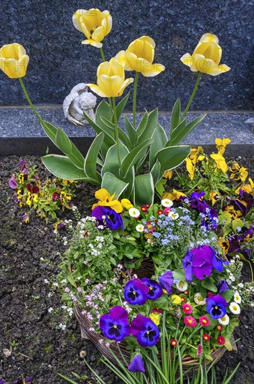 Grave with floral decoration and cherub at the cemetery church of St Stephan, Irsee, Swabia,