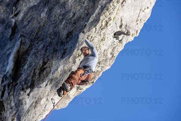 Sport climbing with rope, climber on a rock face, Frauenwasserl climbing garden, Ammergau Alps,