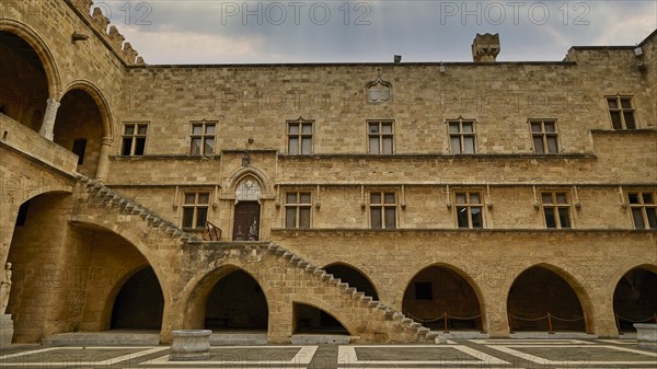 Courtyard of a castle with archways, columns and a stone staircase, sky replaced, courtyard, Grand
