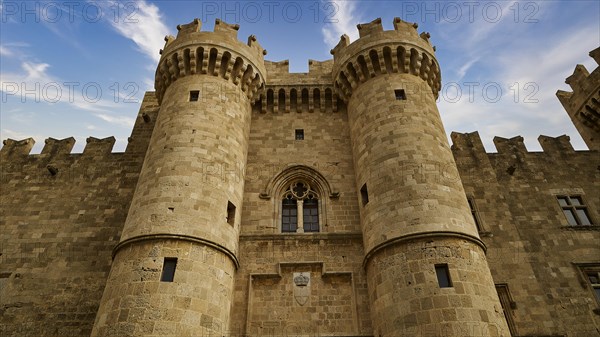 Detailed view of two tin towers of the castle in front of a cloudy sky, main portal, Grand Master's