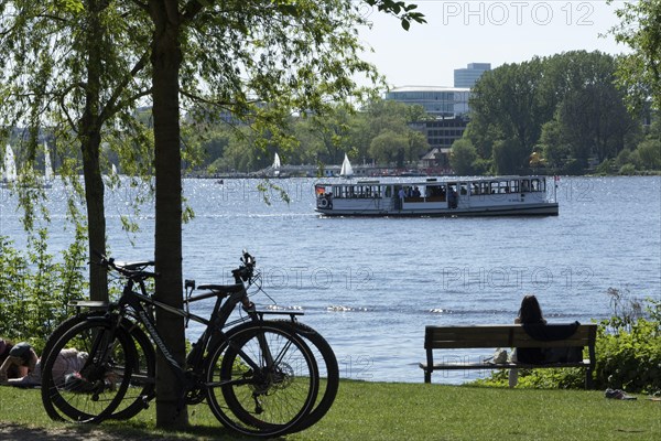 Symbolic image weather, leisure activity, summer spring, silhouette of bicycles and a woman on a