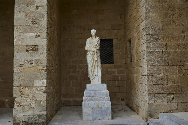 Antique statue of a character in traditional garb on a pedestal, torso from Rhodes, marble head