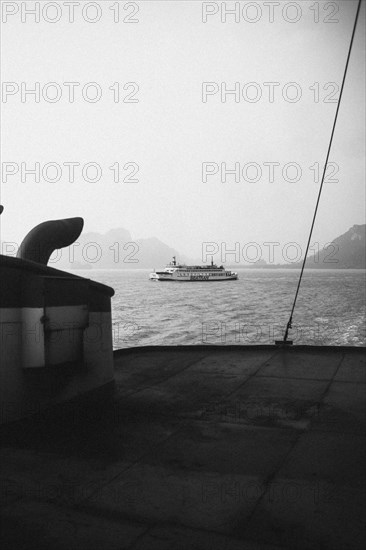 View of a passing ship from the deck in high-contrast black and white. Surat Thani, Thailand, Asia