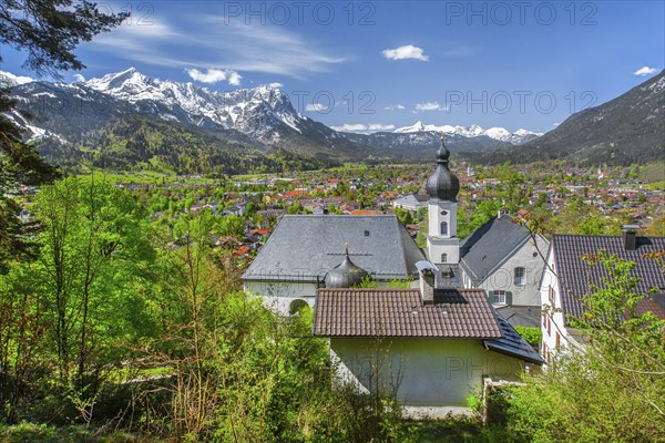 Pilgrimage church St. Anton in spring above the village in front of the Zugspitze group 2962m in