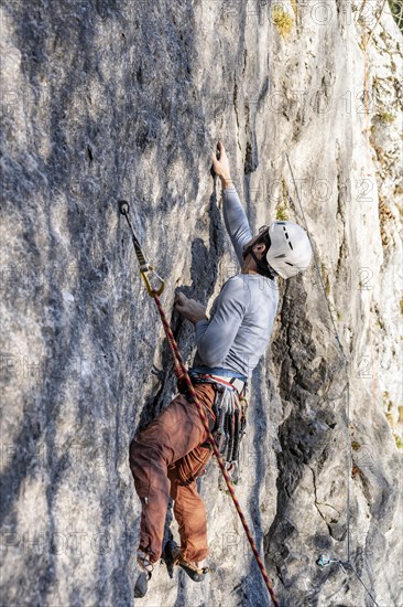 Sport climbing with rope, climber on a rock face, Frauenwasserl climbing garden, Ammergau Alps,