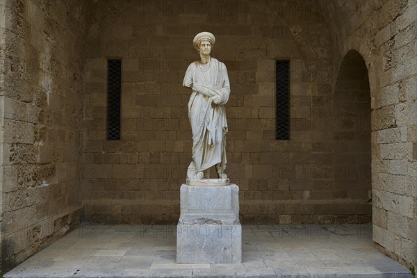 Full view of a statue on a column in historical context, statue from the island of Kos, courtyard,