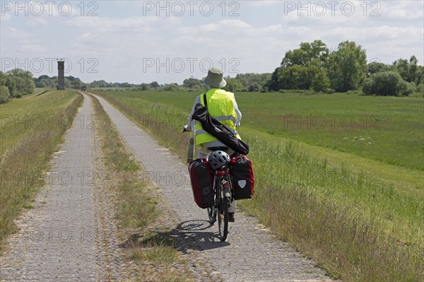 Cyclist, former watchtower, Elbe cycle path near Boizenburg, Mecklenburg-Western Pomerania,