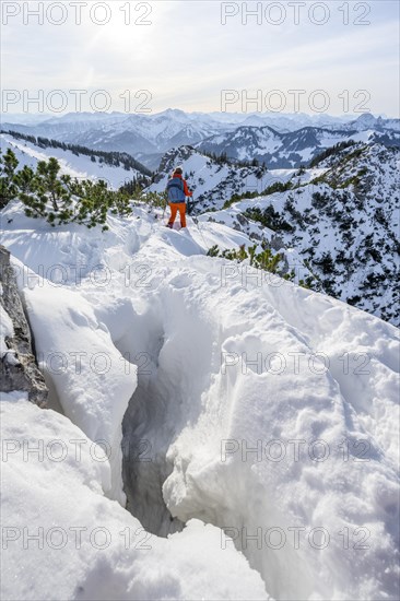 Hiker in winter climbing the Aiplspitz, Mangfall mountains, Bavarian Prealps, Bavaria, Tyrol,