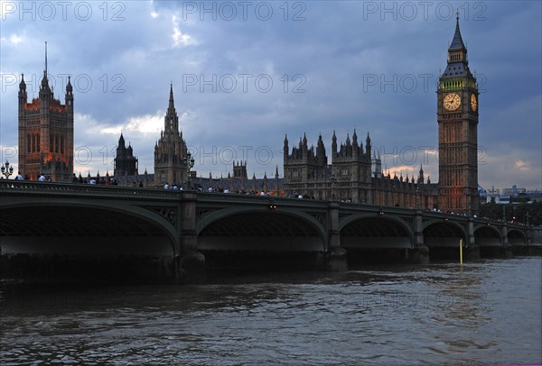 Big Ben with Westminster Hall at dusk in front of Westminster Bridge with the River Thames, London