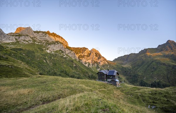 Alpine club hut, Hochweisssteinhaus mountain hut, mountain landscape with green mountain meadows