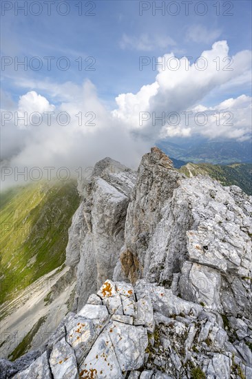 Rocky narrow summit ridge, cloudy mountain peak, summit of the Great Kinigat, Carnic Main Ridge,