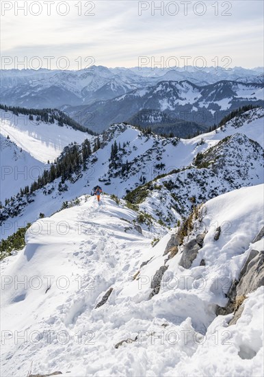Hikers in winter descending the Aiplspitz, Mangfall mountains, Bavarian Prealps, Bavaria, Tyrol,