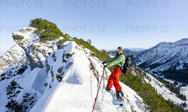 Mountaineer on the ridge of the Aiplspitz in the snow, snow-covered mountain landscape with