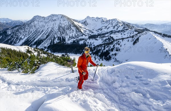Mountaineer at the summit of the Aiplspitz in the snow, snow-covered mountain landscape with