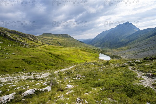 Mountain lake between green mountain meadows in a mountain valley, Oberer Stuckensee in the upper
